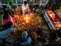 Family and friends light candles at the graves of departed ones to commemorate All Souls Day at a cemetery in Hyderabad, on November 2, 2024...