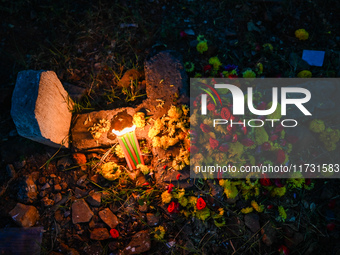 A grave is adorned with flowers and candles during All Souls Day at a Christian cemetery in Hyderabad, on November 2, 2024. (