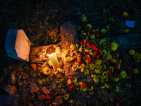 A grave is adorned with flowers and candles during All Souls Day at a Christian cemetery in Hyderabad, on November 2, 2024. (