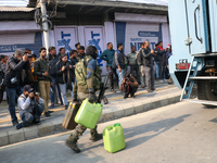 Indian paramilitary troopers carry fuel as they move towards an encounter site in Srinagar, Indian Administered Kashmir, on November 2, 2024...