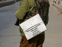 An Indian policeman carries tear gas munitions near the encounter site in Srinagar, Indian Administered Kashmir, on November 2, 2024. Three...