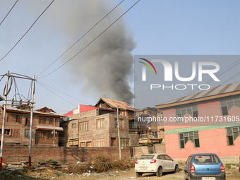 Smoke billows from a residential house where a gunbattle between Indian forces and militants ensues in Srinagar, Indian-administered Kashmir...