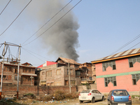 Smoke billows from a residential house where a gunbattle between Indian forces and militants ensues in Srinagar, Indian-administered Kashmir...