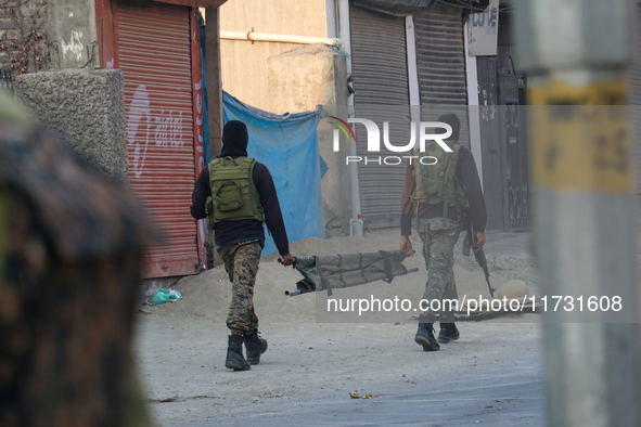 Indian paramilitary troopers carry a stretcher near the encounter site in Srinagar, Indian Administered Kashmir, on November 2, 2024. Three...