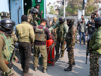 Indian paramilitary troopers carry a flamethrower as they move towards an encounter site in Srinagar, Indian Administered Kashmir, on Novemb...