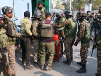 Indian paramilitary troopers carry a flamethrower as they move towards an encounter site in Srinagar, Indian Administered Kashmir, on Novemb...