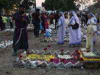 People light candles and lay flowers on the graves of their relatives at a cemetery during All Souls Day in Kolkata, India, on November 2, 2...