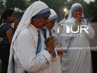 People light candles and lay flowers on the graves of their relatives at a cemetery during All Souls Day in Kolkata, India, on November 2, 2...