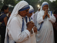 People light candles and lay flowers on the graves of their relatives at a cemetery during All Souls Day in Kolkata, India, on November 2, 2...