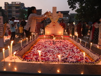 People light candles and lay flowers on the graves of their relatives at a cemetery during All Souls Day in Kolkata, India, on November 2, 2...