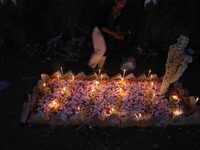 People light candles and lay flowers on the graves of their relatives at a cemetery during All Souls Day in Kolkata, India, on November 2, 2...