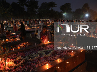 People light candles and lay flowers on the graves of their relatives at a cemetery during All Souls Day in Kolkata, India, on November 2, 2...