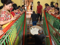 Indian devotees collect holy rice during the Annakut Utsav (Govardhan Puja) at Madan Mohon Mandir in Kolkata, India, on November 2, 2024. Pe...