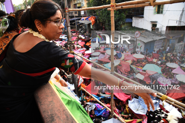 Shashi Panja, Minister of Women and Child Development and Social Welfare of West Bengal, and Indian devotees collect holy rice during the An...