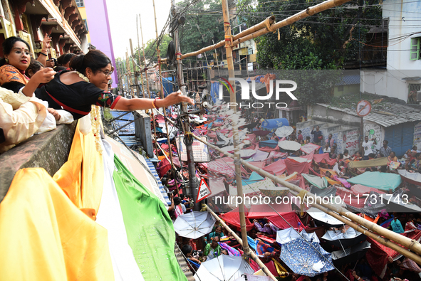 Shashi Panja, Minister of Women and Child Development and Social Welfare of West Bengal, and Indian devotees collect holy rice during the An...