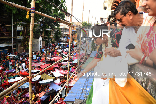 Shashi Panja, Minister of Women and Child Development and Social Welfare of West Bengal, and Indian devotees collect holy rice during the An...