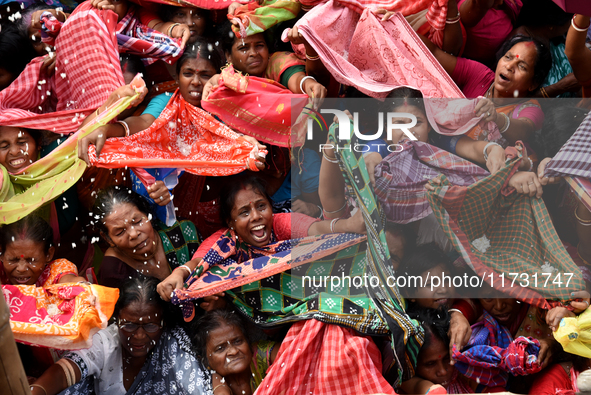 Indian devotees collect holy rice during the Annakut Utsav (Govardhan Puja) at Madan Mohon Mandir in Kolkata, India, on November 2, 2024. Pe...