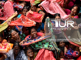 Indian devotees collect holy rice during the Annakut Utsav (Govardhan Puja) at Madan Mohon Mandir in Kolkata, India, on November 2, 2024. Pe...