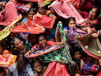 Indian devotees collect holy rice during the Annakut Utsav (Govardhan Puja) at Madan Mohon Mandir in Kolkata, India, on November 2, 2024. Pe...