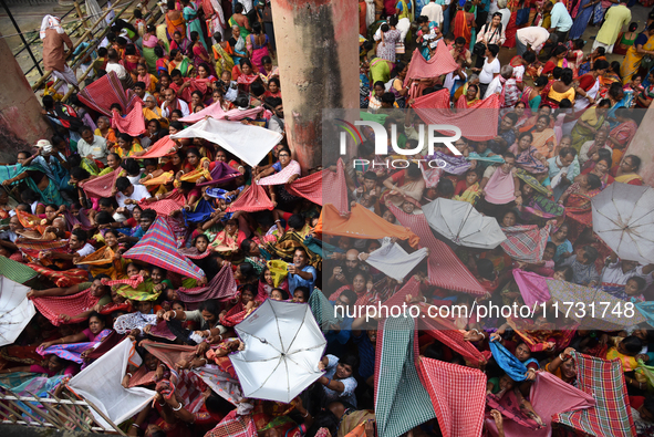 Indian devotees collect holy rice during the Annakut Utsav (Govardhan Puja) at Madan Mohon Mandir in Kolkata, India, on November 2, 2024. Pe...