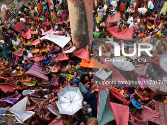 Indian devotees collect holy rice during the Annakut Utsav (Govardhan Puja) at Madan Mohon Mandir in Kolkata, India, on November 2, 2024. Pe...