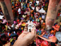 Indian devotees collect holy rice during the Annakut Utsav (Govardhan Puja) at Madan Mohon Mandir in Kolkata, India, on November 2, 2024. Pe...