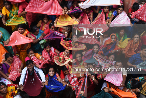 Indian devotees collect holy rice during the Annakut Utsav (Govardhan Puja) at Madan Mohon Mandir in Kolkata, India, on November 2, 2024. Pe...