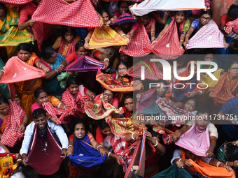 Indian devotees collect holy rice during the Annakut Utsav (Govardhan Puja) at Madan Mohon Mandir in Kolkata, India, on November 2, 2024. Pe...