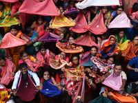 Indian devotees collect holy rice during the Annakut Utsav (Govardhan Puja) at Madan Mohon Mandir in Kolkata, India, on November 2, 2024. Pe...