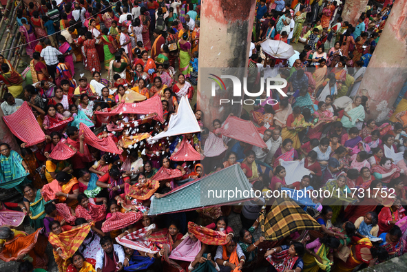 Indian devotees collect holy rice during the Annakut Utsav (Govardhan Puja) at Madan Mohon Mandir in Kolkata, India, on November 2, 2024. Pe...