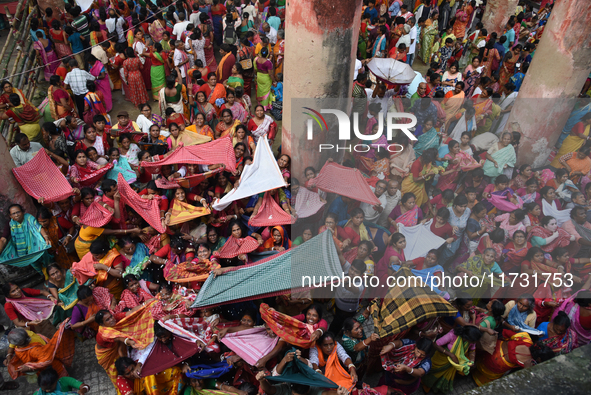 Indian devotees collect holy rice during the Annakut Utsav (Govardhan Puja) at Madan Mohon Mandir in Kolkata, India, on November 2, 2024. Pe...