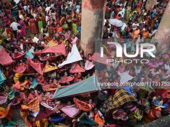 Indian devotees collect holy rice during the Annakut Utsav (Govardhan Puja) at Madan Mohon Mandir in Kolkata, India, on November 2, 2024. Pe...