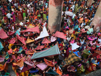 Indian devotees collect holy rice during the Annakut Utsav (Govardhan Puja) at Madan Mohon Mandir in Kolkata, India, on November 2, 2024. Pe...