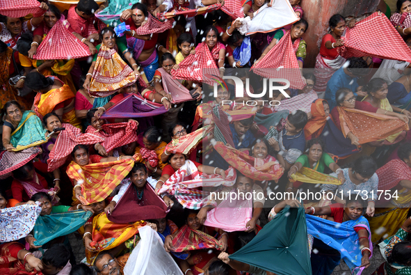 Indian devotees collect holy rice during the Annakut Utsav (Govardhan Puja) at Madan Mohon Mandir in Kolkata, India, on November 2, 2024. Pe...