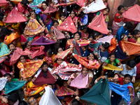 Indian devotees collect holy rice during the Annakut Utsav (Govardhan Puja) at Madan Mohon Mandir in Kolkata, India, on November 2, 2024. Pe...