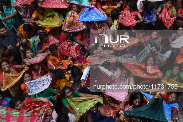 Indian devotees collect holy rice during the Annakut Utsav (Govardhan Puja) at Madan Mohon Mandir in Kolkata, India, on November 2, 2024. Pe...