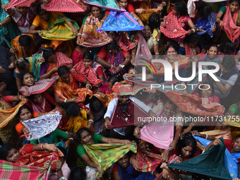 Indian devotees collect holy rice during the Annakut Utsav (Govardhan Puja) at Madan Mohon Mandir in Kolkata, India, on November 2, 2024. Pe...