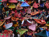 Indian devotees collect holy rice during the Annakut Utsav (Govardhan Puja) at Madan Mohon Mandir in Kolkata, India, on November 2, 2024. Pe...