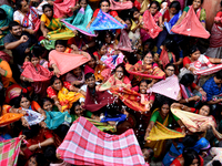 Indian devotees collect holy rice during the Annakut Utsav (Govardhan Puja) at Madan Mohon Mandir in Kolkata, India, on November 2, 2024. Pe...