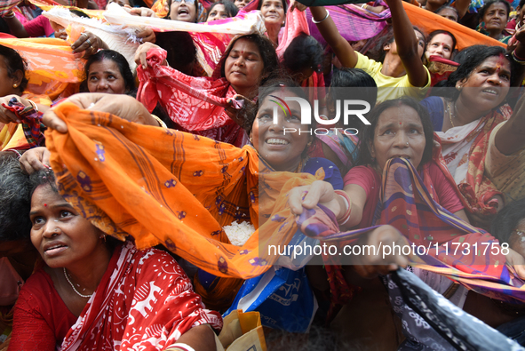 Indian devotees collect holy rice during the Annakut Utsav (Govardhan Puja) at Madan Mohon Mandir in Kolkata, India, on November 2, 2024. Pe...