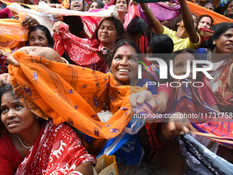 Indian devotees collect holy rice during the Annakut Utsav (Govardhan Puja) at Madan Mohon Mandir in Kolkata, India, on November 2, 2024. Pe...