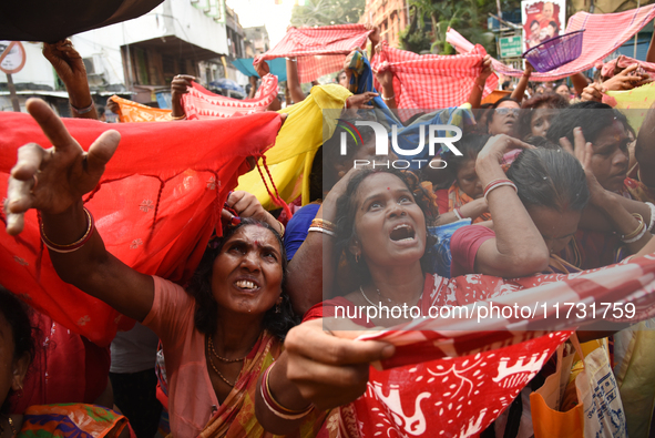 Indian devotees collect holy rice during the Annakut Utsav (Govardhan Puja) at Madan Mohon Mandir in Kolkata, India, on November 2, 2024. Pe...