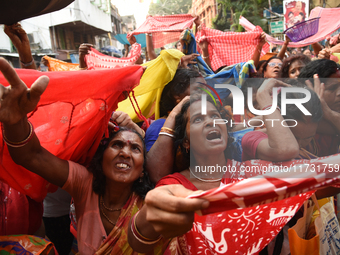 Indian devotees collect holy rice during the Annakut Utsav (Govardhan Puja) at Madan Mohon Mandir in Kolkata, India, on November 2, 2024. Pe...