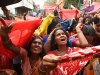 Indian devotees collect holy rice during the Annakut Utsav (Govardhan Puja) at Madan Mohon Mandir in Kolkata, India, on November 2, 2024. Pe...