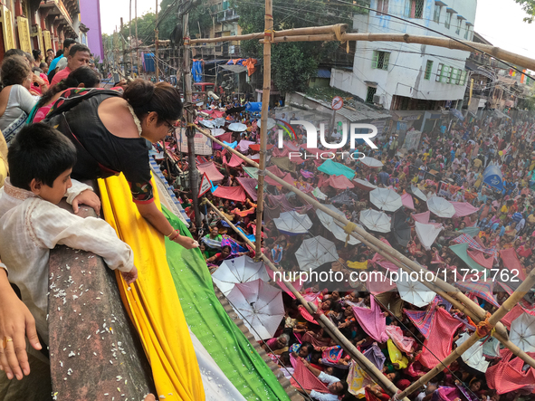 Shashi Panja, Minister of Women and Child Development and Social Welfare of West Bengal, and Indian devotees collect holy rice during the An...