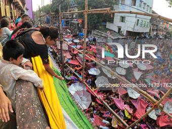 Shashi Panja, Minister of Women and Child Development and Social Welfare of West Bengal, and Indian devotees collect holy rice during the An...