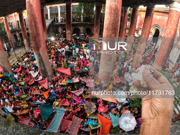 Indian devotees collect holy rice during the Annakut Utsav (Govardhan Puja) at Madan Mohon Mandir in Kolkata, India, on November 2, 2024. Pe...