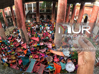 Indian devotees collect holy rice during the Annakut Utsav (Govardhan Puja) at Madan Mohon Mandir in Kolkata, India, on November 2, 2024. Pe...