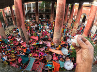 Indian devotees collect holy rice during the Annakut Utsav (Govardhan Puja) at Madan Mohon Mandir in Kolkata, India, on November 2, 2024. Pe...