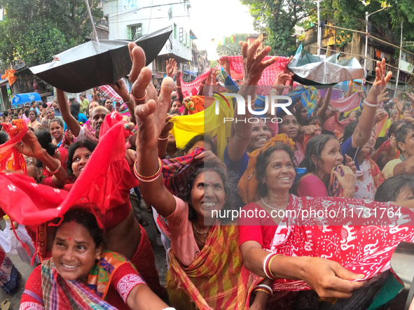 Indian devotees collect holy rice during the Annakut Utsav (Govardhan Puja) at Madan Mohon Mandir in Kolkata, India, on November 2, 2024. Pe...